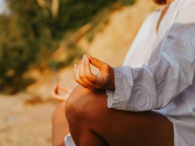 Close-up of a person's hands in a graceful yoga mudra.