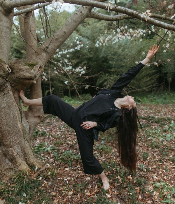Person performing a flowing yoga sequence in a calm environment.