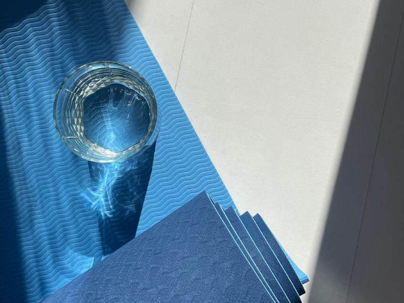 Spacious, minimalist room with a yoga mat prepared for practice.